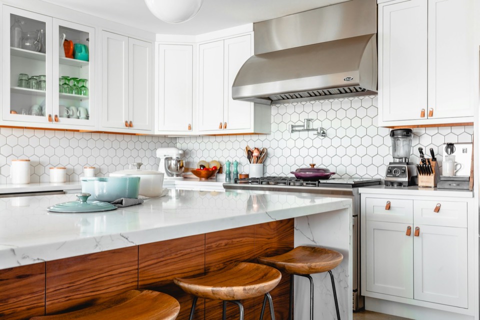 Bright modern kitchen with white cabinetry and home appliances